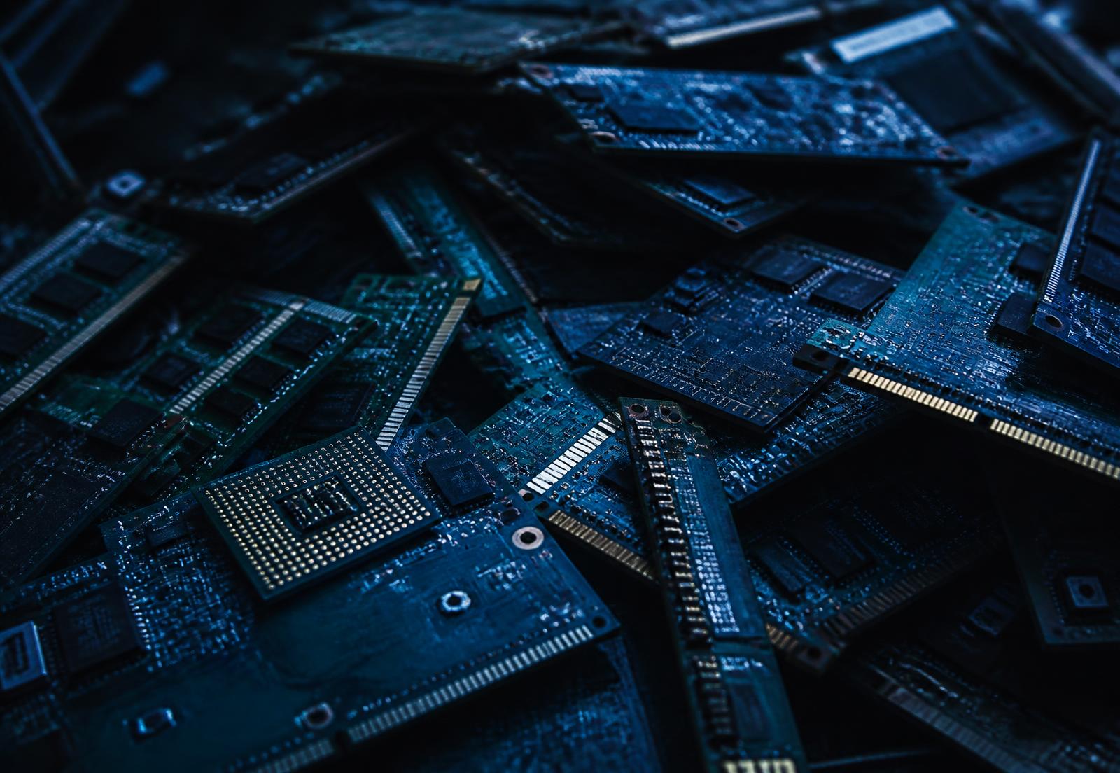 Dense pile of discarded circuit boards and electronic components